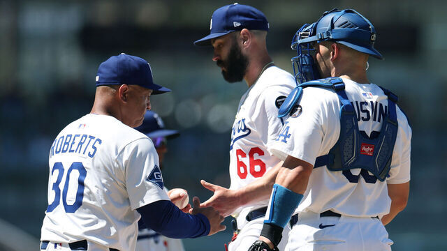 LOS ANGELES, CALIFORNIA - JULY 06: Dave Roberts #30 of the Los Angeles Dodgers takes the ball from Tanner Scott #66 in front of Dalton Rushing #68 during the eighth inning against the Houston Astros at Dodger Stadium on July 06, 2025 in Los Angeles, California.