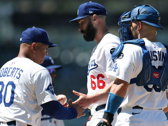 LOS ANGELES, CALIFORNIA - JULY 06: Dave Roberts #30 of the Los Angeles Dodgers takes the ball from Tanner Scott #66 in front of Dalton Rushing #68 during the eighth inning against the Houston Astros at Dodger Stadium on July 06, 2025 in Los Angeles, California.