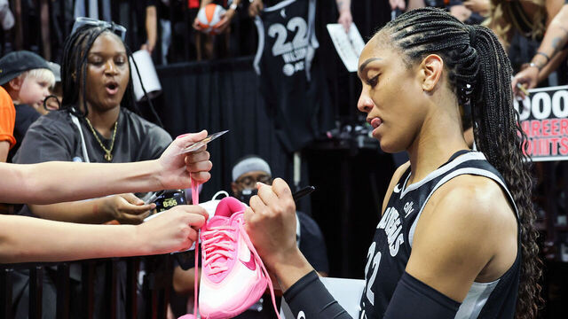 LAS VEGAS, NEVADA - JUNE 25: A'ja Wilson #22 of the Las Vegas Aces signs a pair of her Nike A'One signature shoes after the Aces' 85-59 victory over the Connecticut Sun at Michelob ULTRA Arena on June 25, 2025 in Las Vegas, Nevada.