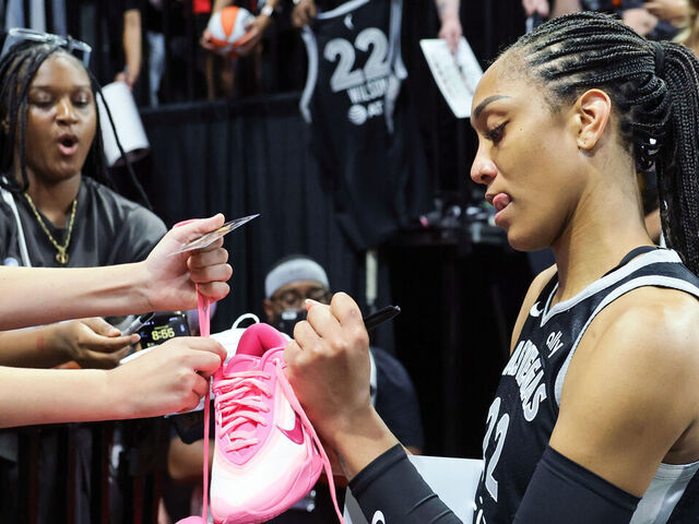 LAS VEGAS, NEVADA - JUNE 25: A'ja Wilson #22 of the Las Vegas Aces signs a pair of her Nike A'One signature shoes after the Aces' 85-59 victory over the Connecticut Sun at Michelob ULTRA Arena on June 25, 2025 in Las Vegas, Nevada.