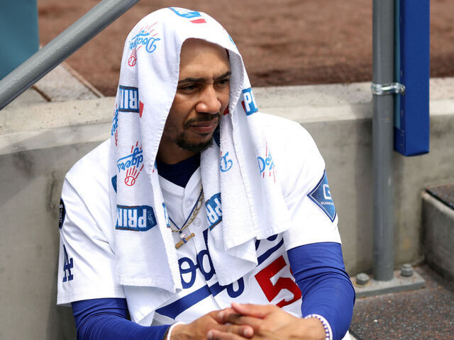 LOS ANGELES, CALIFORNIA - APRIL 30: Mookie Betts #50 of the Los Angeles Dodgers looks on from the dugout during the second inning against the Miami Marlins at Dodger Stadium on April 30, 2025 in Los Angeles, California.