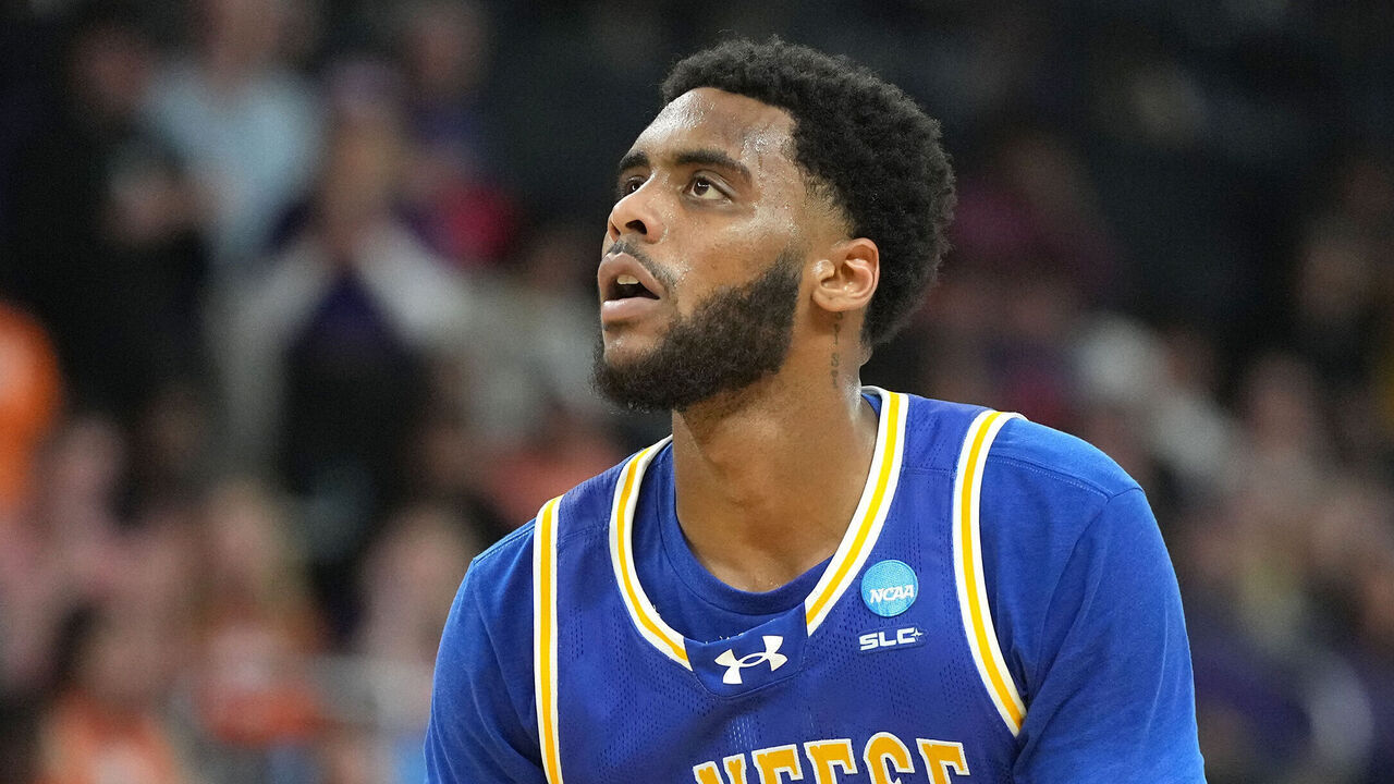 PROVIDENCE, RHODE ISLAND - MARCH 20: Sincere Parker #21 of the McNeese State Cowboys takes a free throw during a first-round game against the Clemson Tigers in the NCAA Men's Basketball Tournament at Amica Mutual Pavillion on March 20, 2025 in Providence, Rhode Island.