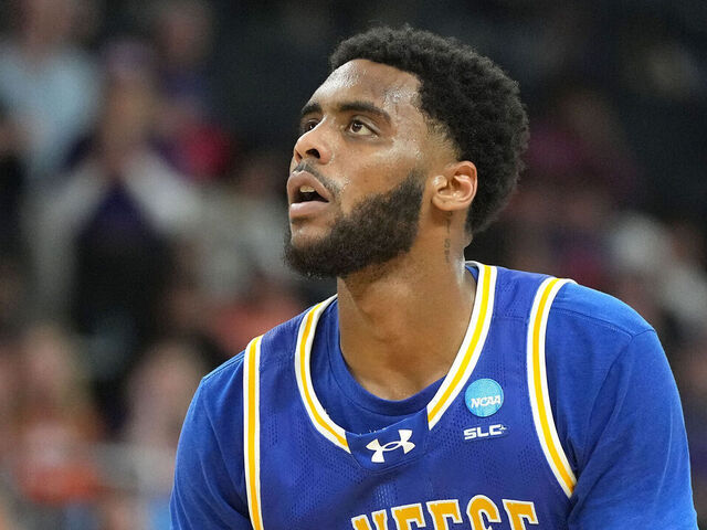 PROVIDENCE, RHODE ISLAND - MARCH 20: Sincere Parker #21 of the McNeese State Cowboys takes a free throw during a first-round game against the Clemson Tigers in the NCAA Men's Basketball Tournament at Amica Mutual Pavillion on March 20, 2025 in Providence, Rhode Island.