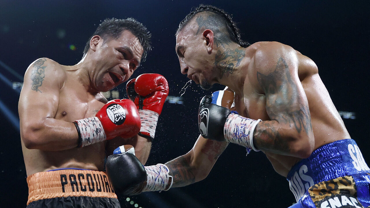LAS VEGAS, NEVADA - JULY 19: Mario Barrios (R) punches Manny Pacquiao during their WBC welterweight title fight ending in a majority draw at MGM Grand Garden Arena on July 19, 2025 in Las Vegas, Nevada.