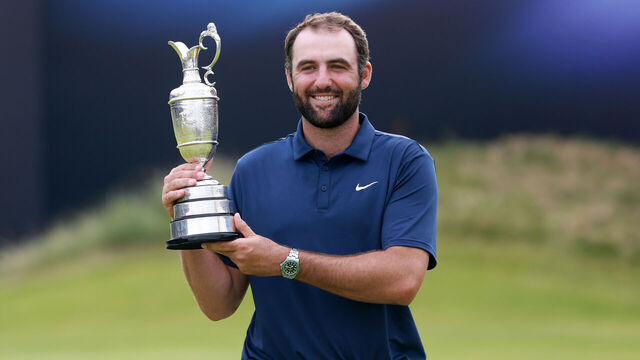 PORTRUSH, NORTHERN IRELAND - JULY 20: Scottie Scheffler of the United States poses with the Claret Jug on the 18th green after winning The 153rd Open Championship at Royal Portrush Golf Club on July 20, 2025 in Portrush, Northern Ireland.