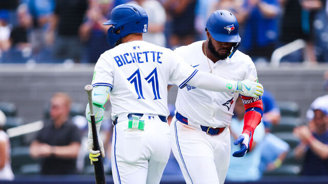 TORONTO, CANADA - JULY 20: Bo Bichette #11 embraces Vladimir Guerrero Jr. #27 of the Toronto Blue Jays after Guerrero Jr.'s solo-home run in the first inning of their MLB game against the San Francisco Giants Rogers Centre on July 20, 2025 in Toronto, Canada.