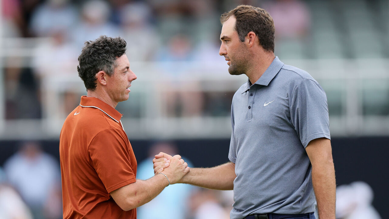CHARLOTTE, NORTH CAROLINA - MAY 16: Rory McIlroy of Northern Ireland, left, shakes hands with Scottie Scheffler of the United States on the 18th hole green after finishing the second round of the PGA Championship at Quail Hollow Country Club on May 16, 2025 in Charlotte, North Carolina.