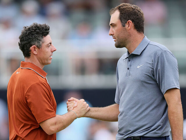 CHARLOTTE, NORTH CAROLINA - MAY 16: Rory McIlroy of Northern Ireland, left, shakes hands with Scottie Scheffler of the United States on the 18th hole green after finishing the second round of the PGA Championship at Quail Hollow Country Club on May 16, 2025 in Charlotte, North Carolina.