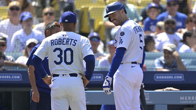 LOS ANGELES, CALIFORNIA - JULY 20: Freddie Freeman #5 of the Los Angeles Dodgers looks as manager Dave Roberts #30 as he leaves the game after getting hit by a pitch during the sixth inning against the Milwaukee Brewers at Dodger Stadium on July 20, 2025 in Los Angeles, California.
