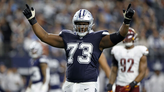 ARLINGTON, TEXAS - JANUARY 05: Tyler Smith #73 of the Dallas Cowboys reacts against the Washington Commanders during the third quarter at AT&T Stadium on January 05, 2025 in Arlington, Texas.
