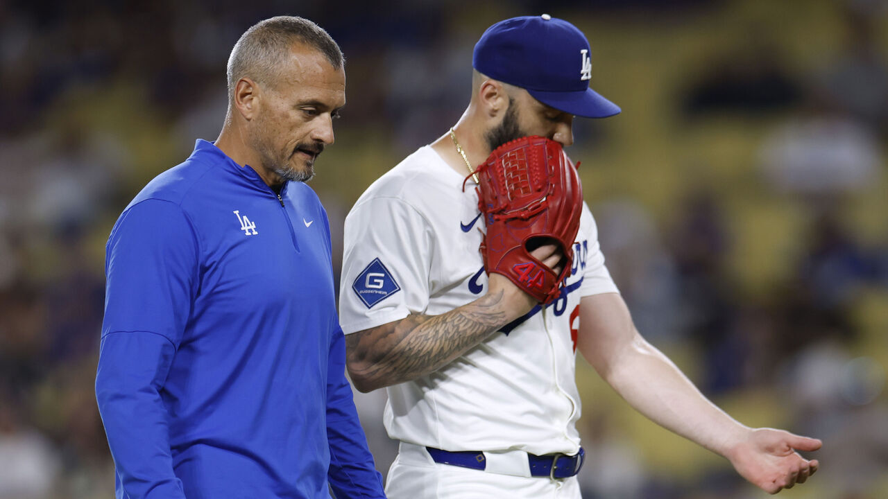 LOS ANGELES, CALIFORNIA - JULY 21: Tanner Scott #66 of the Los Angeles Dodgers reacts as he leaves the game with medical staff during the ninth inning against the Minnesota Twins at Dodger Stadium on July 21, 2025 in Los Angeles, California.