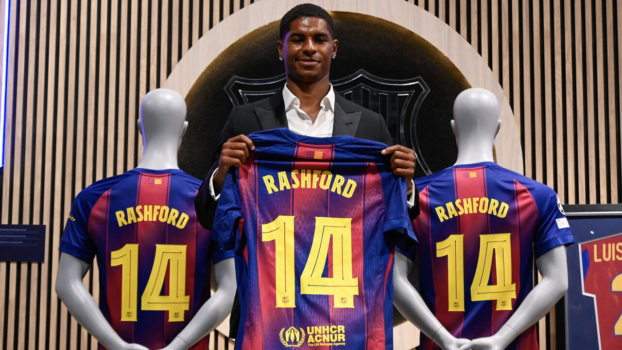 English forward Marcus Rashford who joined Barcelona on loan from Manchester United holds up his jersey during his official presentation at the Camp Nou stadium in Barcelona on July 23, 2025. Barcelona and Manchester United have reached a deal for the loan of the player Marcus Rashford until June 30, 2026," announced the La Liga champions in a statement.