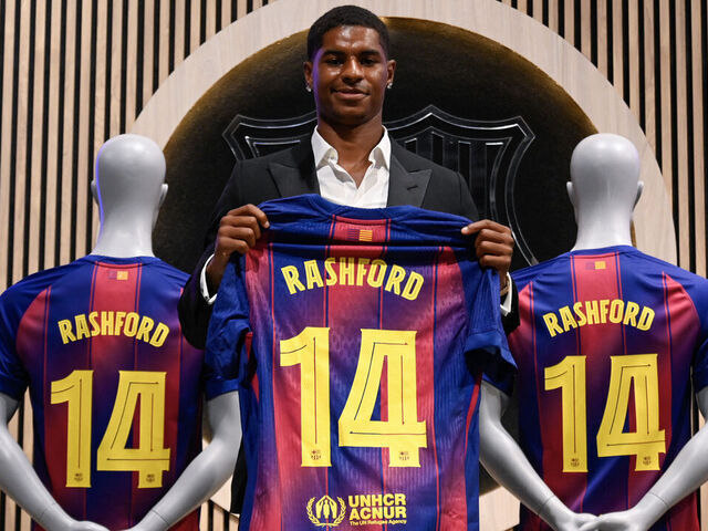 English forward Marcus Rashford who joined Barcelona on loan from Manchester United holds up his jersey during his official presentation at the Camp Nou stadium in Barcelona on July 23, 2025. Barcelona and Manchester United have reached a deal for the loan of the player Marcus Rashford until June 30, 2026," announced the La Liga champions in a statement.