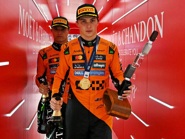 SPA, BELGIUM - JULY 27: Race winner Oscar Piastri of Australia and McLaren and Second placed Lando Norris of Great Britain and McLaren leave the podium with their trophies during the F1 Grand Prix of Belgium at Circuit de Spa-Francorchamps on July 27, 2025 in Spa, Belgium.