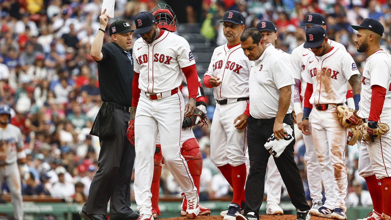 BOSTON, MA - JULY 27: As Manager Alex Cora #13 of the Boston Red Sox looks on, pitcher Aroldis Chapman #44 leaves the game with an injury during the eighth inning against the Los Angeles Dodgers at Fenway Park on July 27, 2025 in Boston, Massachusetts.