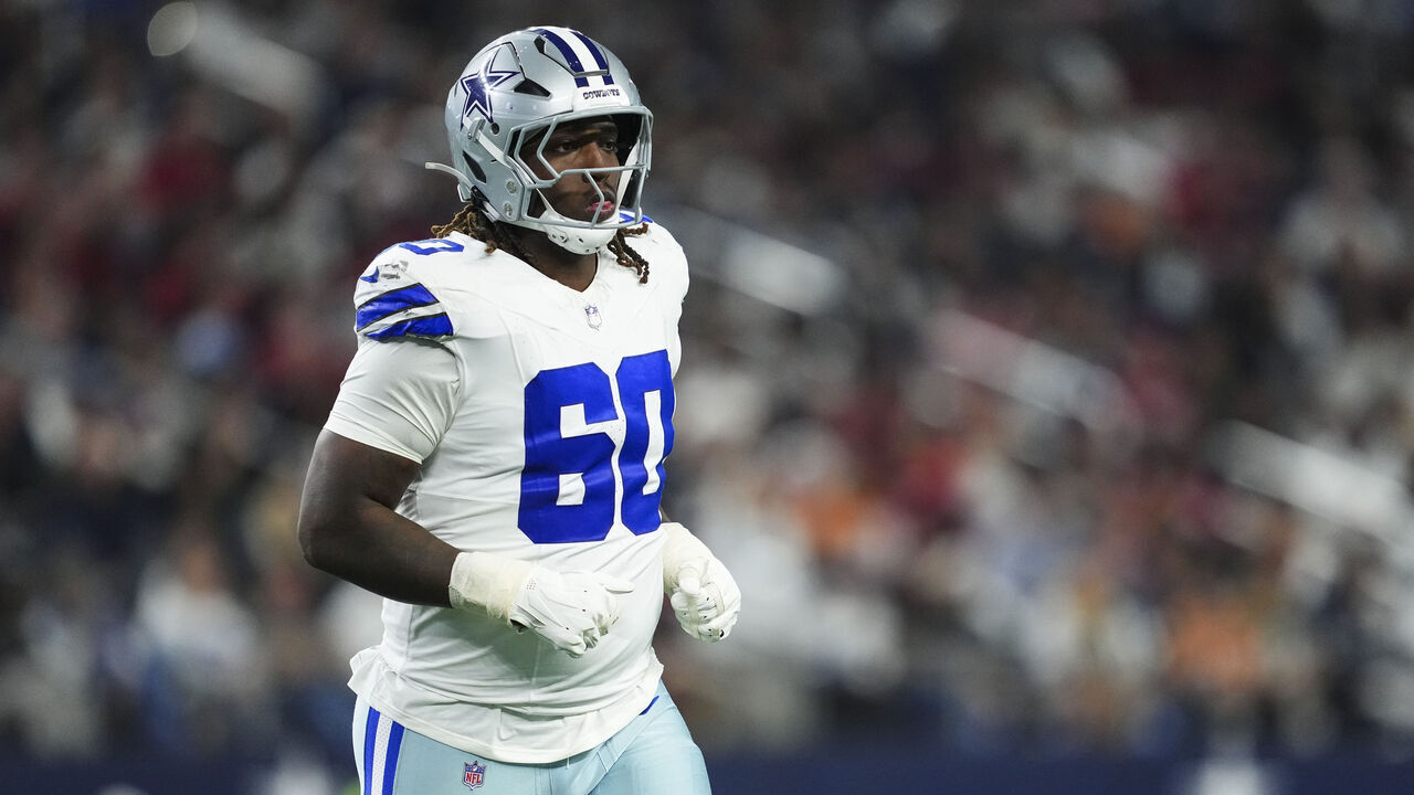 ARLINGTON, TX - DECEMBER 22: Tyler Guyton #60 of the Dallas Cowboys looks on from the field during an NFL football game against the Tampa Bay Buccaneers at AT&T Stadium on December 22, 2024 in Arlington, Texas.