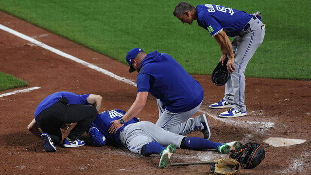 BALTIMORE, MARYLAND - JULY 28: George Springer #4 of the Toronto Blue Jays is injured after being hit by a pitch in the helmet by pitcher Kade Strowd #57 of the Baltimore Orioles (not pictured) during the ninth inning at Oriole Park at Camden Yards on July 28, 2025 in Baltimore, Maryland.