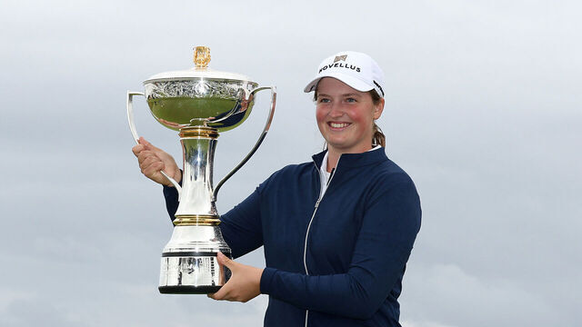 TROON, SCOTLAND - JULY 27: Lottie Woad of England poses with the trophy on the 18th green following victory in the final round of the ISPS HANDA Women's Scottish Open 2025 at Dundonald Links Golf Course on July 27, 2025 in Troon, Scotland.