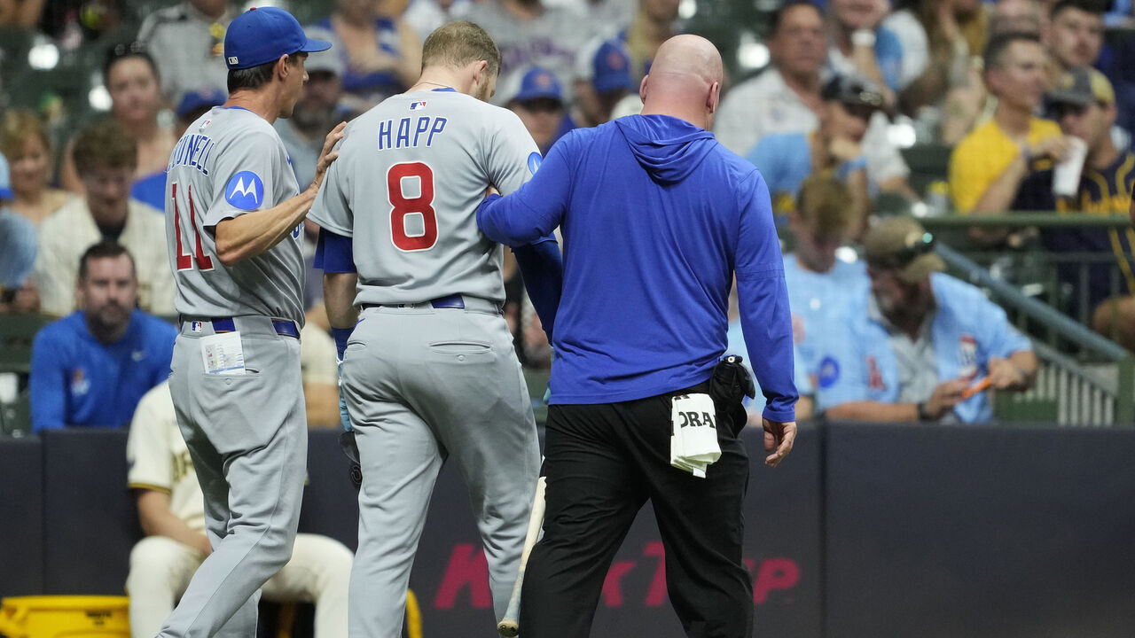 MILWAUKEE, WISCONSIN - JULY 29: Ian Happ #8 of the Chicago Cubs is helped back to the dugout by manager Craig Counsell #11 and a team trainer after an apparent injury during the eighth inning against the Milwaukee Brewers at American Family Field on July 29, 2025 in Milwaukee, Wisconsin.