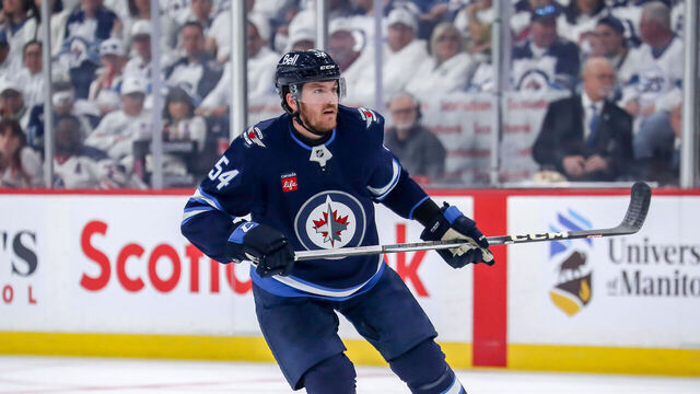 WINNIPEG, CANADA - MAY 7: Dylan Samberg #54 of the Winnipeg Jets keeps an eye on the play during first period action against the Dallas Stars in Game One of the Second Round of the 2025 Stanley Cup Playoffs at the Canada Life Centre on May 7, 2025 in Winnipeg, Manitoba, Canada. The Stars defeated the Jets 3-2 and lead the series 1-0.
