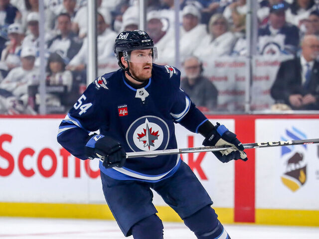WINNIPEG, CANADA - MAY 7: Dylan Samberg #54 of the Winnipeg Jets keeps an eye on the play during first period action against the Dallas Stars in Game One of the Second Round of the 2025 Stanley Cup Playoffs at the Canada Life Centre on May 7, 2025 in Winnipeg, Manitoba, Canada. The Stars defeated the Jets 3-2 and lead the series 1-0.