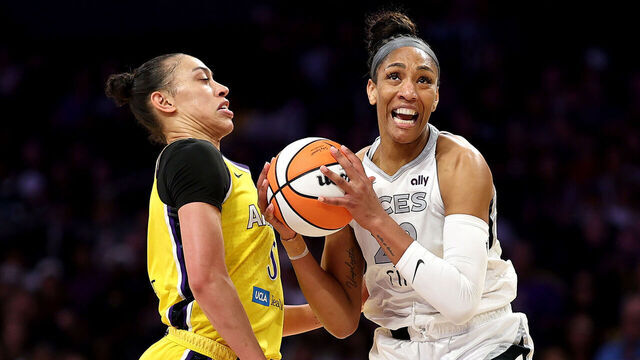 LOS ANGELES, CALIFORNIA - JULY 29: A'ja Wilson #22 of the Las Vegas Aces dribbles the ball against Dearica Hamby #5 of the Los Angeles Sparks during the first half at Crypto.com Arena on July 29, 2025 in Los Angeles, California.