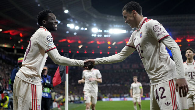 LEVERKUSEN, GERMANY - MARCH 11: Alphonso Davies of Bayern Munich (L) celebrates scoring his team's second goal with teammate Jamal Musiala during the UEFA Champions League 2024/25 Round of 16 second leg match between Bayer 04 Leverkusen and FC Bayern München at BayArena on March 11, 2025 in Leverkusen, Germany.