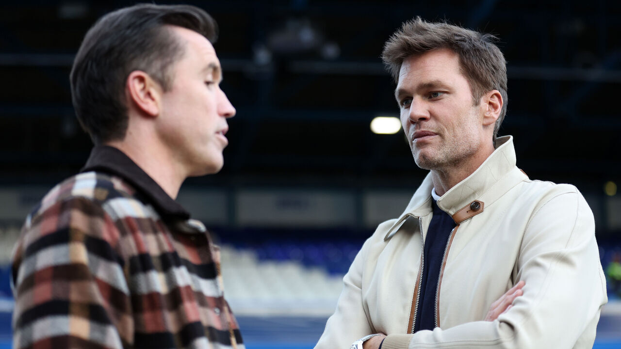 BIRMINGHAM, ENGLAND - SEPTEMBER 16: Rob McElhenney co - owner of Wrexham speaks to Tom Brady ahead of the Sky Bet League One match between Birmingham City FC and Wrexham AFC at St Andrew’s at Knighthead Park on September 16, 2024 in Birmingham, England.