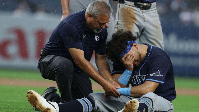 NEW YORK, NEW YORK - JULY 31: Jonathan Aranda #62 of the Tampa Bay Rays is injured after a collision with Giancarlo Stanton #27 of the New York Yankees in the fifth inning during their game at Yankee Stadium on July 31, 2025 in New York City.