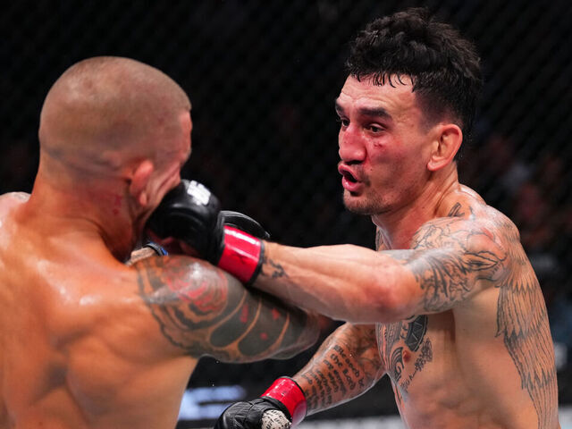 NEW ORLEANS, LOUISIANA - JULY 19: Max Holloway punches Dustin Poirier in the BMF championship bout during the UFC 318 event at Smoothie King Center on July 19, 2025 in New Orleans, Louisiana.