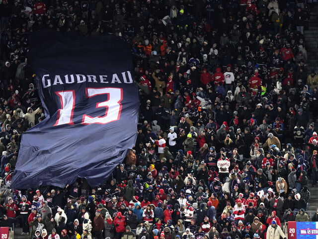 COLUMBUS, OHIO - MARCH 01: A banner commemorating the late Johnny Gaudreau #13 of the Columbus Blue Jackets is passed along by fans in the stadium during the second period of the NHL Stadium Series game between the Detroit Red Wings and the Columbus Blue Jackets at Ohio Stadium on March 01, 2025 in Columbus, Ohio.