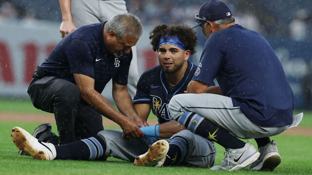 NEW YORK, NEW YORK - JULY 31: Jonathan Aranda #62 of the Tampa Bay Rays is injured after a collision with Giancarlo Stanton #27 of the New York Yankees in the fifth inning during their game at Yankee Stadium on July 31, 2025 in New York City.