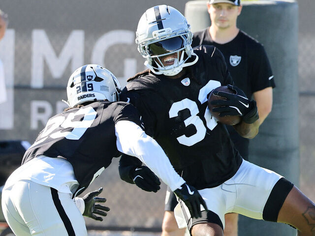 HENDERSON, NEVADA - JULY 28: Chris Smith II #29 and Lonnie Johnson Jr. #32 of the Las Vegas Raiders practice during the team's training camp at the Las Vegas Raiders Headquarters/Intermountain Health Performance Center on July 28, 2025 in Henderson, Nevada.