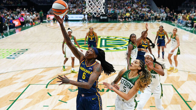 SEATTLE, WASHINGTON - AUGUST 03: Natasha Howard #6 of the Indiana Fever shoots past Gabby Williams #5 of the Seattle Storm during the first half at Climate Pledge Arena on August 03, 2025 in Seattle, Washington.