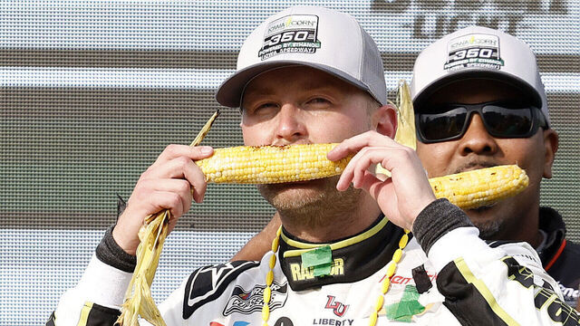 NEWTON, IOWA - AUGUST 03: William Byron, driver of the #24 Raptor Chevrolet, eats corn in celebration in victory lane after winning the NASCAR Cup Series Iowa Corn 350 Powered by Ethanol at Iowa Speedway on August 03, 2025 in Newton, Iowa.