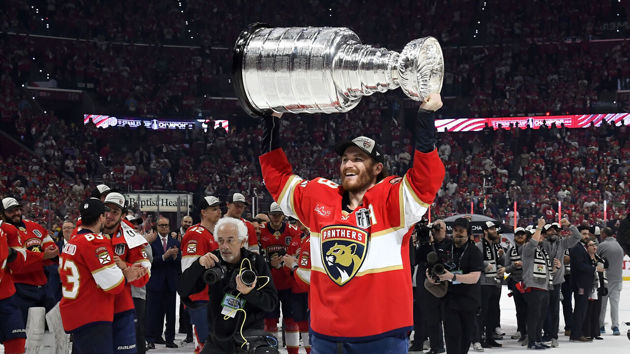 SUNRISE, FLORIDA - JUNE 17: Matthew Tkachuk #19 of the Florida Panthers hoists the Stanley Cup after Game Six of the 2025 Stanley Cup Final between the Edmonton Oilers and the Florida Panthers at Amerant Bank Arena on June 17, 2025 in Sunrise, Florida. The Panthers won the Stanley Cup Final series 4-2.