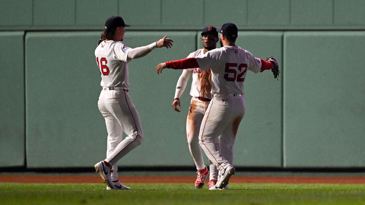 BOSTON, MASSACHUSETTS - AUGUST 04: Jarren Duran #16, Ceddanne Rafaela #3 and Wilyer Abreu #52 of the Boston Red Sox celebrate after a game against the Kansas City Royals at Fenway Park on August 04, 2025 in Boston, Massachusetts.