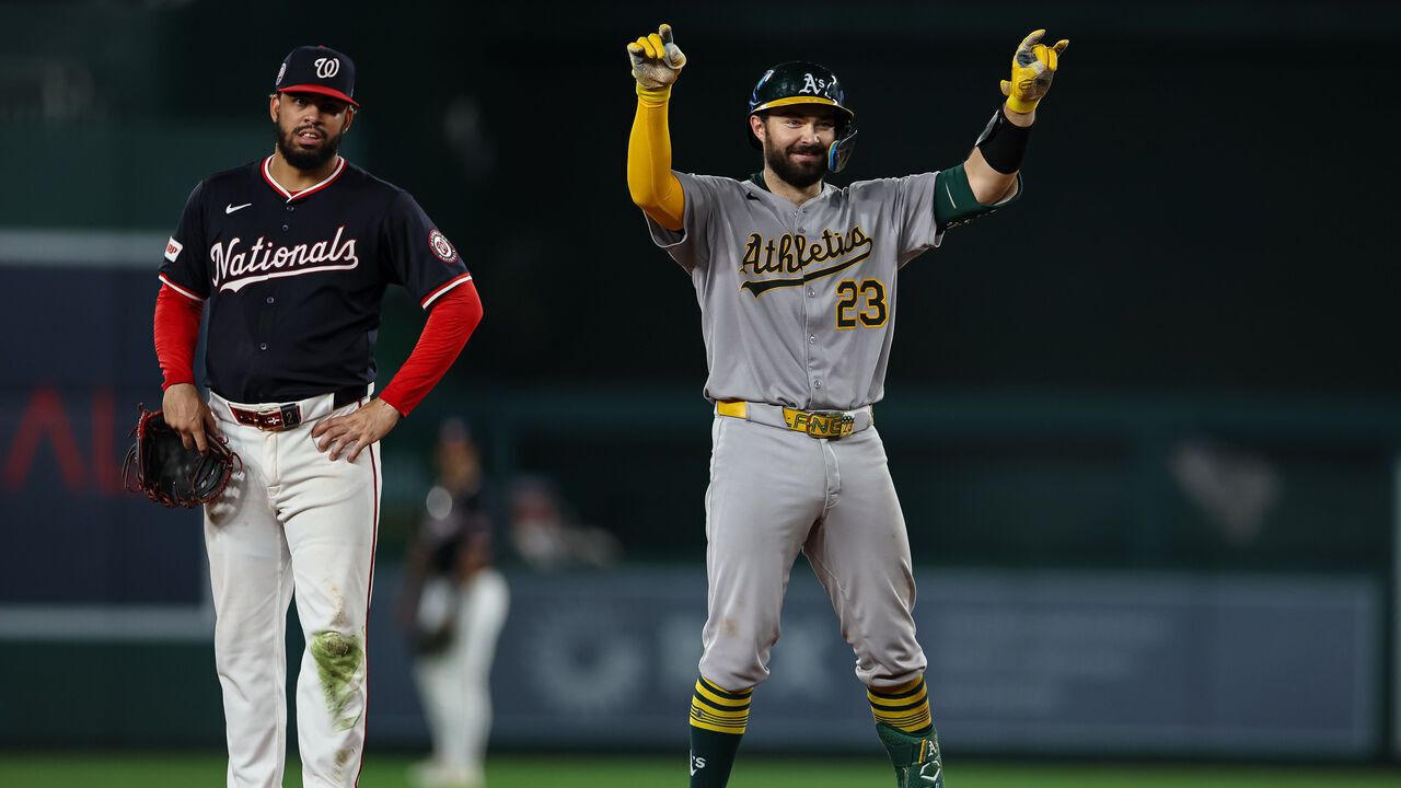 WASHINGTON, DC - AUGUST 05: Shea Langeliers #23 of the Athletics celebrates in front of Luis García Jr. #2 of the Washington Nationals after hitting a double during the eighth inning at Nationals Park on August 5, 2025 in Washington, DC.
