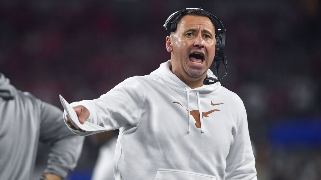 ARLINGTON, TX - JANUARY 10: Texas Longhorns coach Steve Sarkisian tries to get the crowd energized following a third quarter timeout during the Ohio State Buckeyes versus Texas Longhorns College Football Playoff Semifinal at the Cotton Bowl Classic on January 10, 2025, at AT&T Stadium in Arlington, TX.