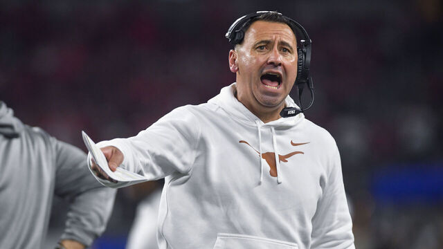 ARLINGTON, TX - JANUARY 10: Texas Longhorns coach Steve Sarkisian tries to get the crowd energized following a third quarter timeout during the Ohio State Buckeyes versus Texas Longhorns College Football Playoff Semifinal at the Cotton Bowl Classic on January 10, 2025, at AT&T Stadium in Arlington, TX.
