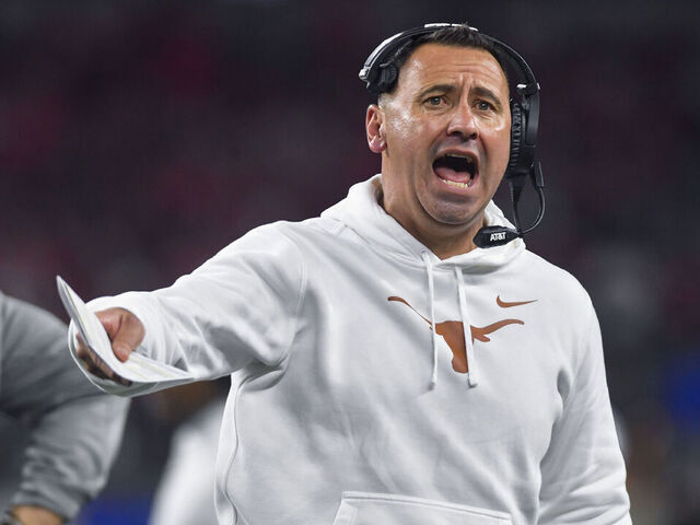 ARLINGTON, TX - JANUARY 10: Texas Longhorns coach Steve Sarkisian tries to get the crowd energized following a third quarter timeout during the Ohio State Buckeyes versus Texas Longhorns College Football Playoff Semifinal at the Cotton Bowl Classic on January 10, 2025, at AT&T Stadium in Arlington, TX.
