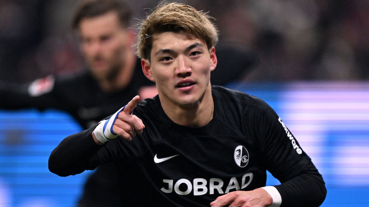 Freiburg's Japanese forward #42 Ritsu Doan celebrates scoring the opening goal 0-1 during the German first division Bundesliga football match between Eintracht Frankfurt and SC Freiburg in Frankfurt am Main, western Germany on January 14, 2025.
