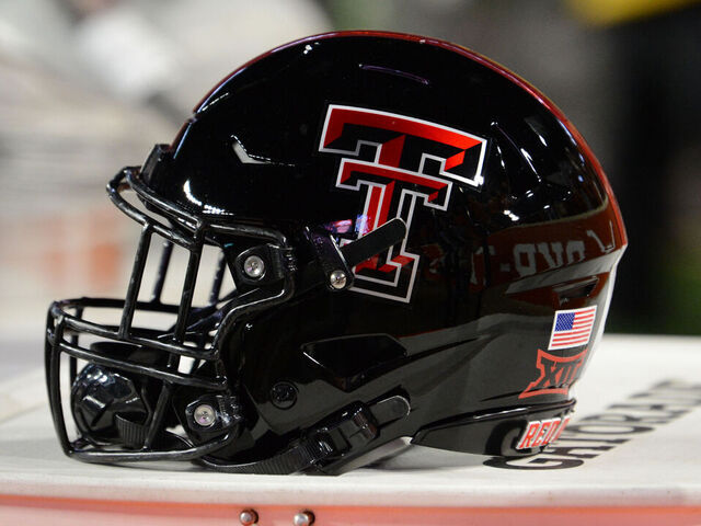 AUSTIN, TX - NOVEMBER 24: A Texas Tech Red Raiders helmet rests on the sidelines during college football game between the Texas Tech Red Raiders and the Texas Longhorns on November 24, 2023, at Darrell K Royal-Texas Memorial Stadium in Austin, TX.