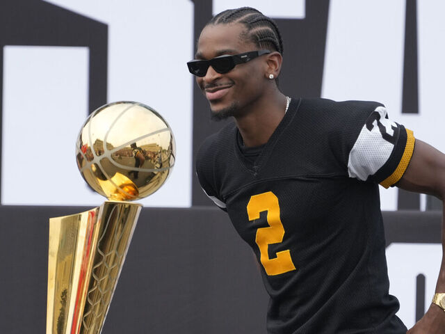 HAMILTON, CANADA - AUGUST 7: Shai Gilgeous-Alexander #2 of the Oklahoma City Thunder and the Larry O'Brien NBA championship trophy on Shai Rally Day held before a game between the BC Lions and Hamilton Tiger-Cats at Hamilton Stadium on August 7, 2025 in Hamilton, Canada.