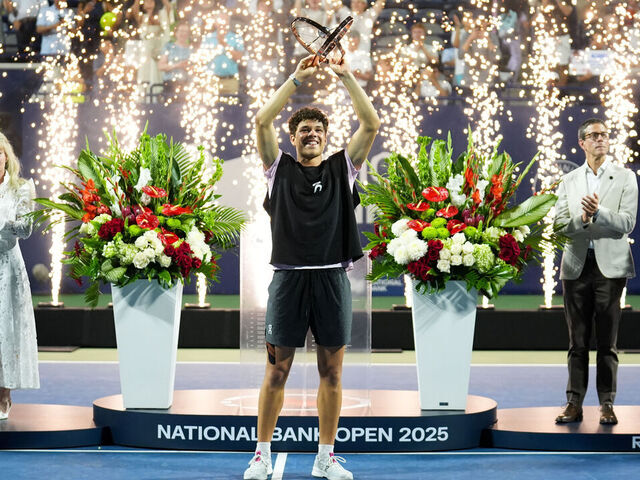 TORONTO, CANADA - AUGUST 7 : Ben Shelton of the United States celebrates with the trophy after winning the men's singles final against Karen Khachanov on day thirteen of the 2025 National Bank Open in Toronto, Ontario, Canada on August 7, 2025.