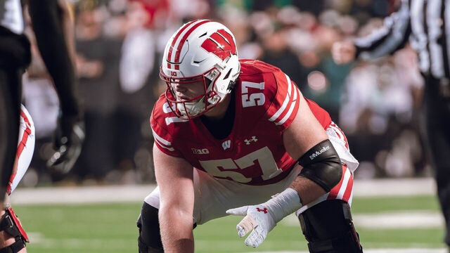 Wisconsin Badgers offensive lineman Jake Renfro #57 and Wisconsin Badgers offensive lineman Joe Brunner #56 get ready before the snap against the Oregon Ducks at Camp Randall Stadium in Madison, Wisconsin, on November 16, 2024.