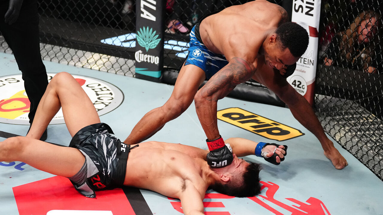 LAS VEGAS, NEVADA - AUGUST 09: (R-L) Elijah Smith knocks out Toshiomi Kazama of Japan in a bantamweight fight during the UFC Fight Night event at UFC APEX on August 09, 2025 in Las Vegas, Nevada.