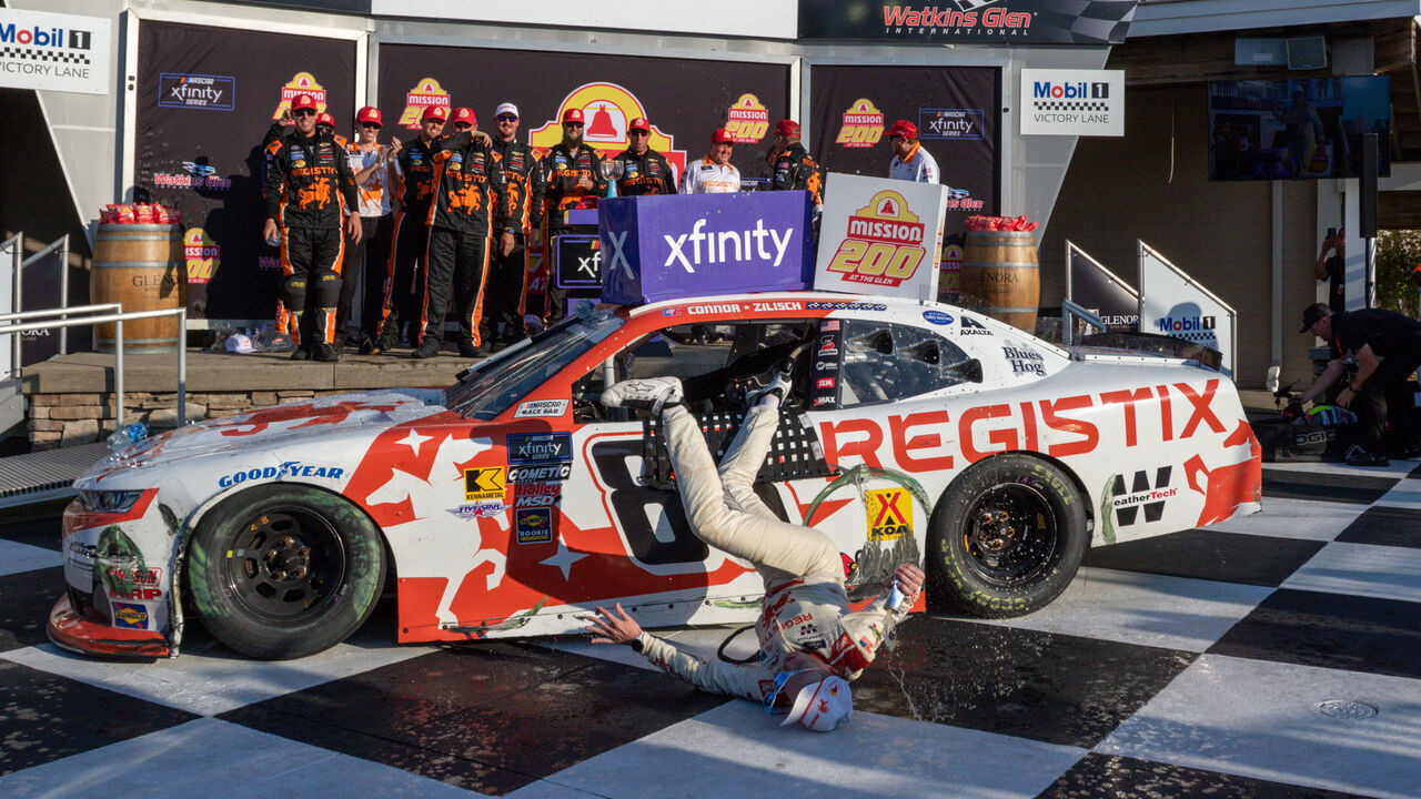 WATKINS GLEN, NY - AUGUST 09: After winning the Mission 200 Connor Zilisch (#88 JR Motorsports Registix Chevrolet) falls from his Registix Chevrolet and hits his head on landing in Victory lane At The Glen on August 09, 2025, at Watkins Glen International in Watkins Glen, NY.