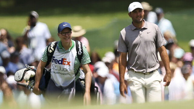 MEMPHIS, TENNESSEE - AUGUST 10: Scottie Scheffler and his caddie Brad Payne walk the first hole during the final round of the FedEx St. Jude Championship 2025 at TPC Southwind on August 10, 2025 in Memphis, Tennessee.