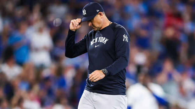 TORONTO, CANADA - JULY 22: Aaron Boone, manager of the New York Yankees walks to the dugout from the mound during their MLB game against the Toronto Blue Jays at Rogers Centre on July 22, 2025 in Toronto, Ontario, Canada.